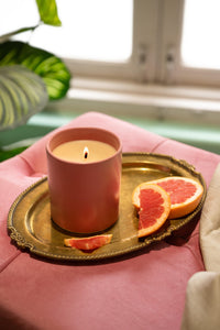 Lit Fête candle creating celebratory ambiance