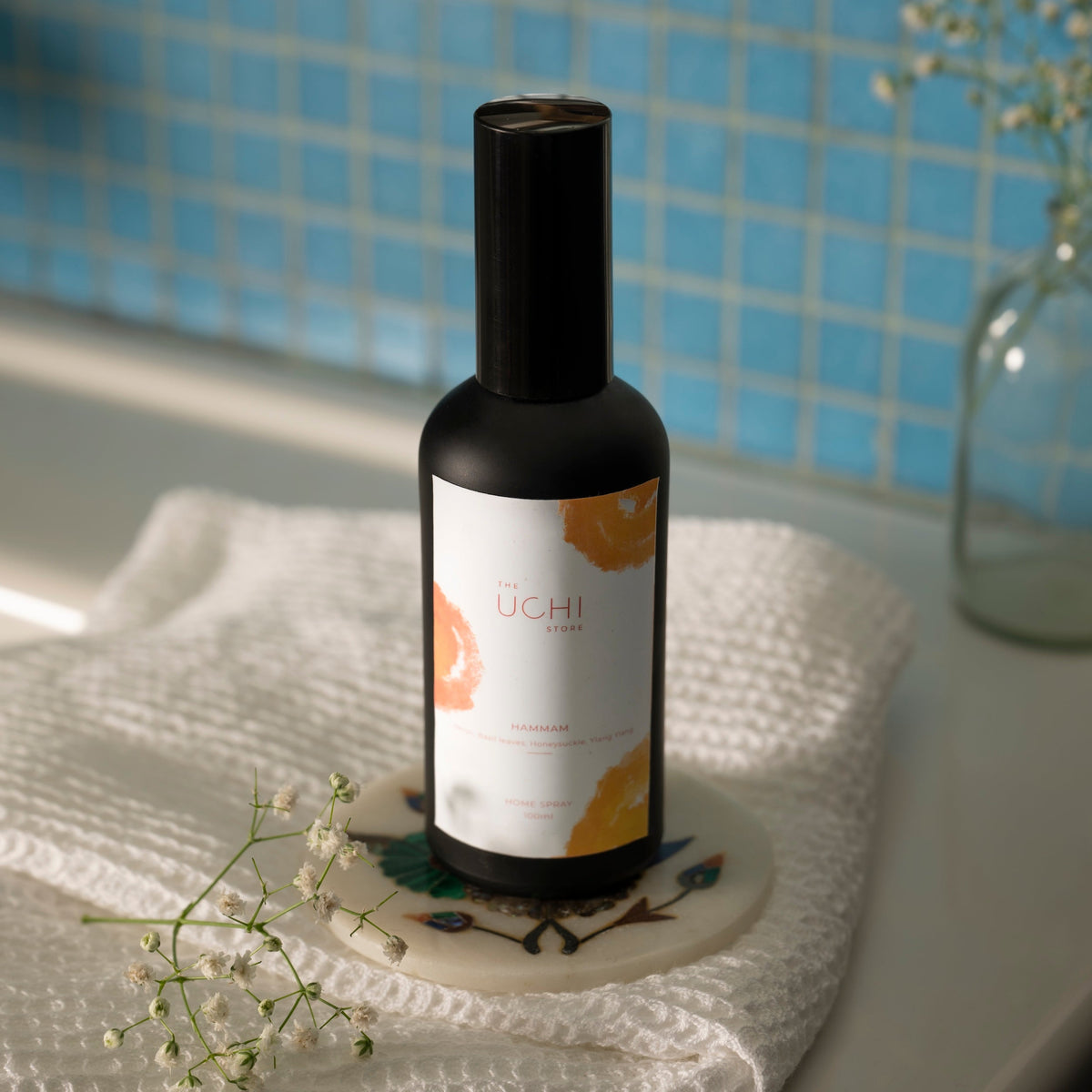 Hammam spray misting over curtain or fabric in tranquil space
