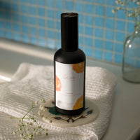 Hammam spray misting over curtain or fabric in tranquil space
