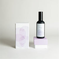 Black glass room fragrance bottle with berries and cocoa notes